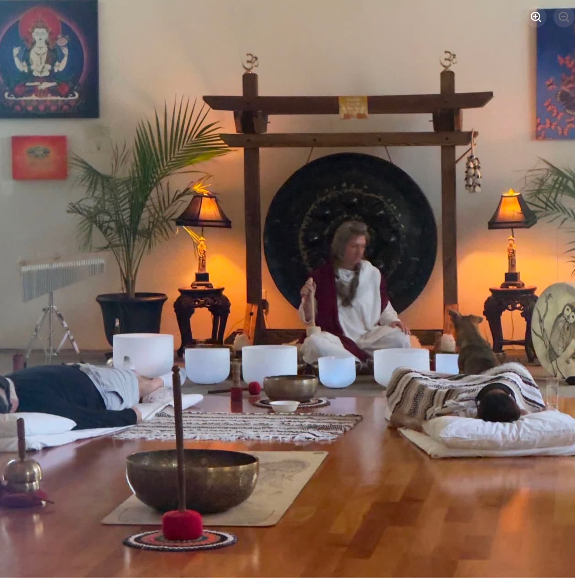 Guests resting in a candlelit sound-healing journey beneath the gong altar in the Cathedral at Sedonya