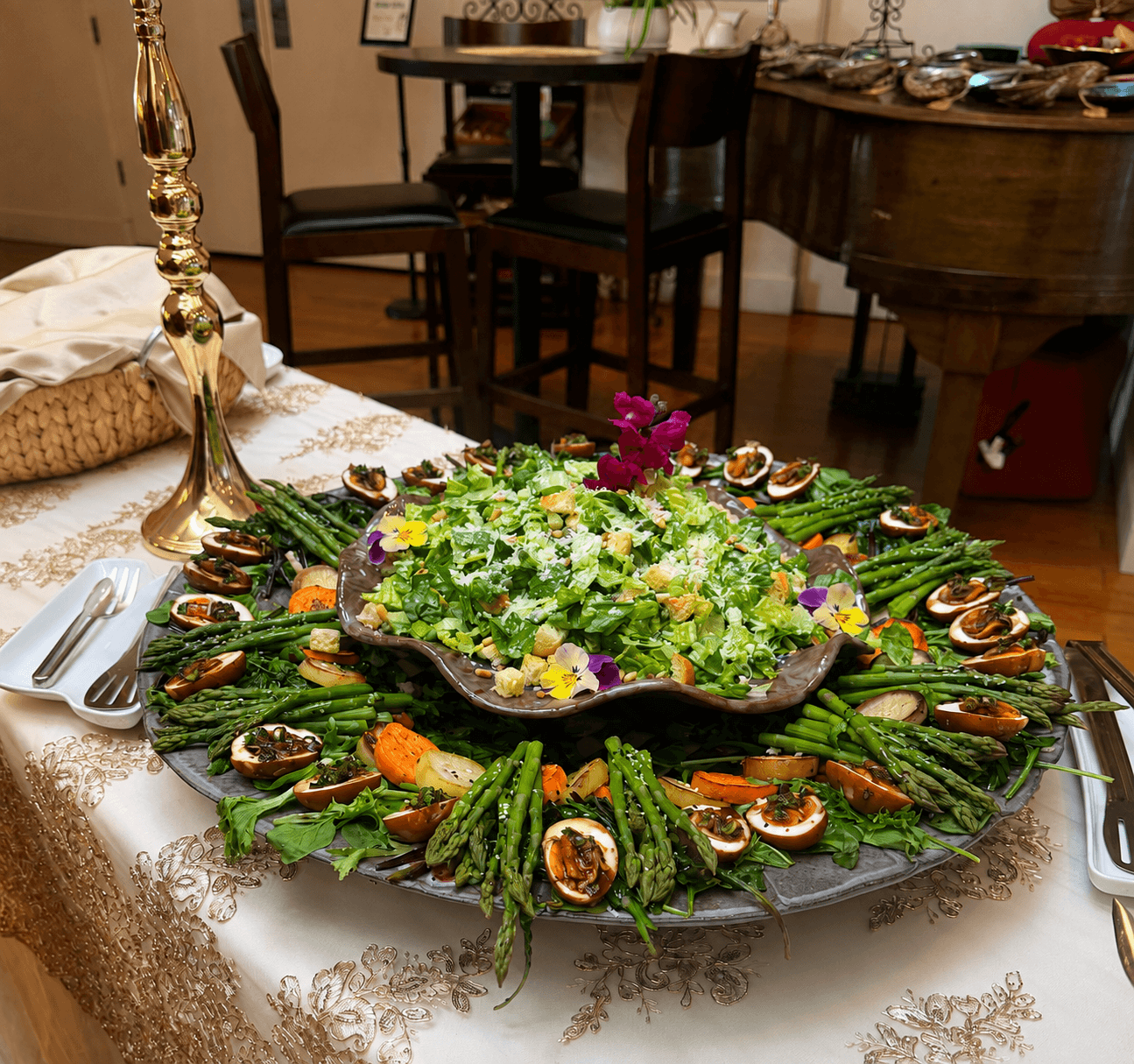 A beautifully arranged salad platter with asparagus, deviled eggs and edible flowers on a linen-covered table