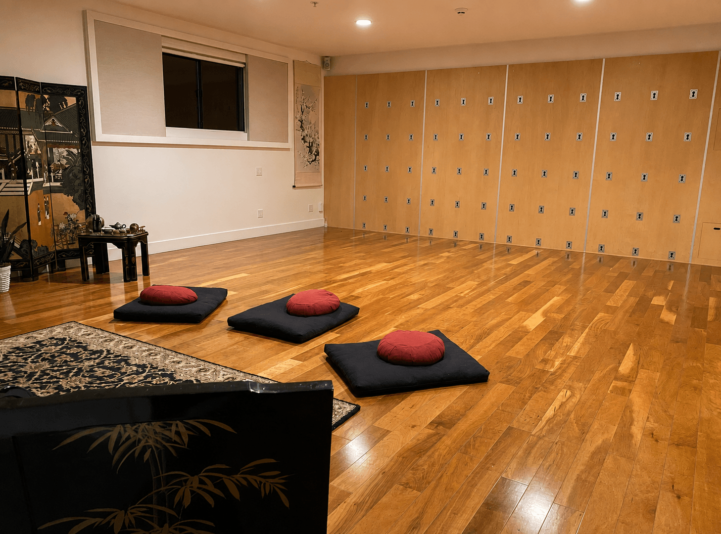 Cushions arranged before the room's wall of lockers, ready for a full class