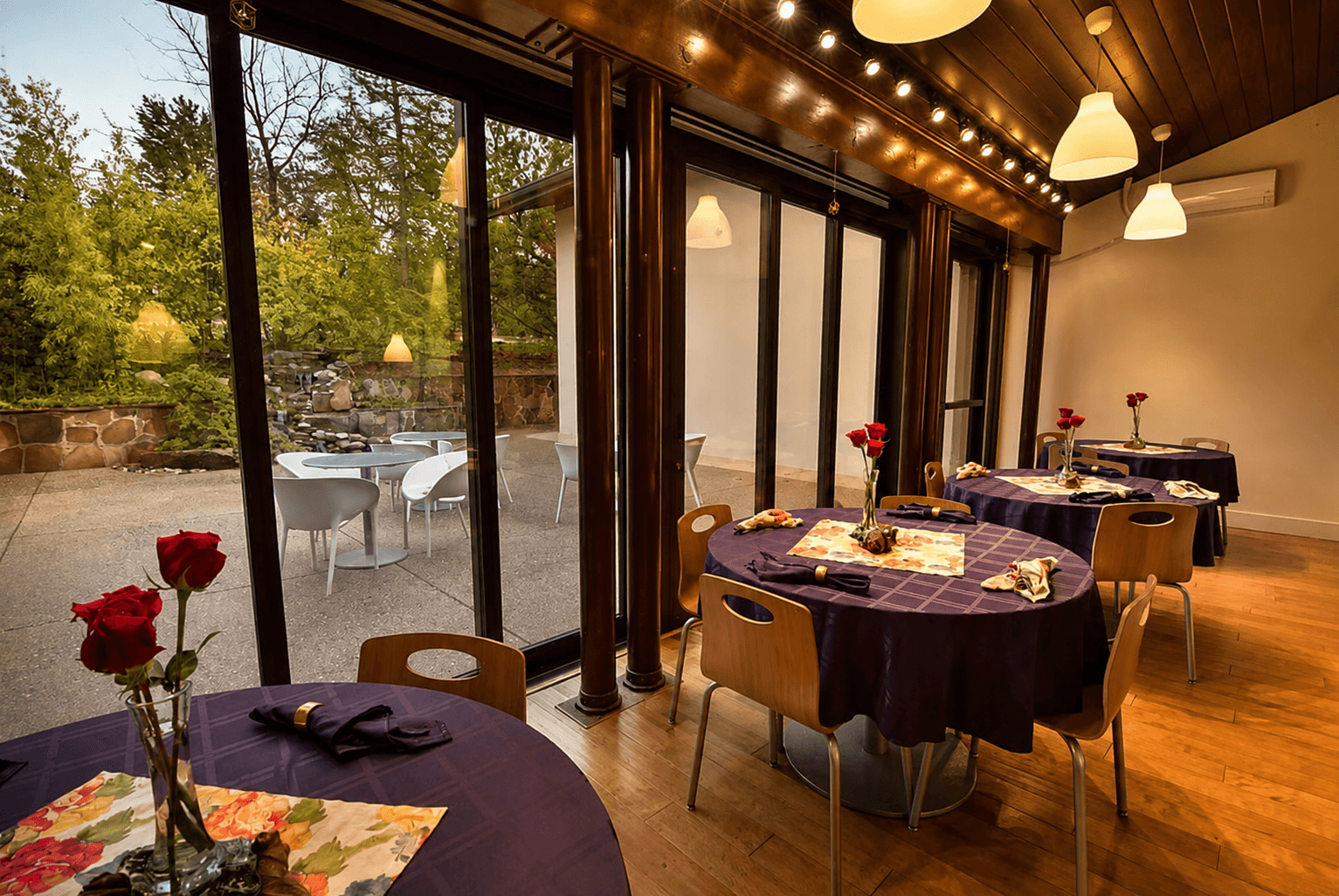 The atrium at Sedonya's Heart Center, warm lamplight and wood columns opening onto the patio and garden
