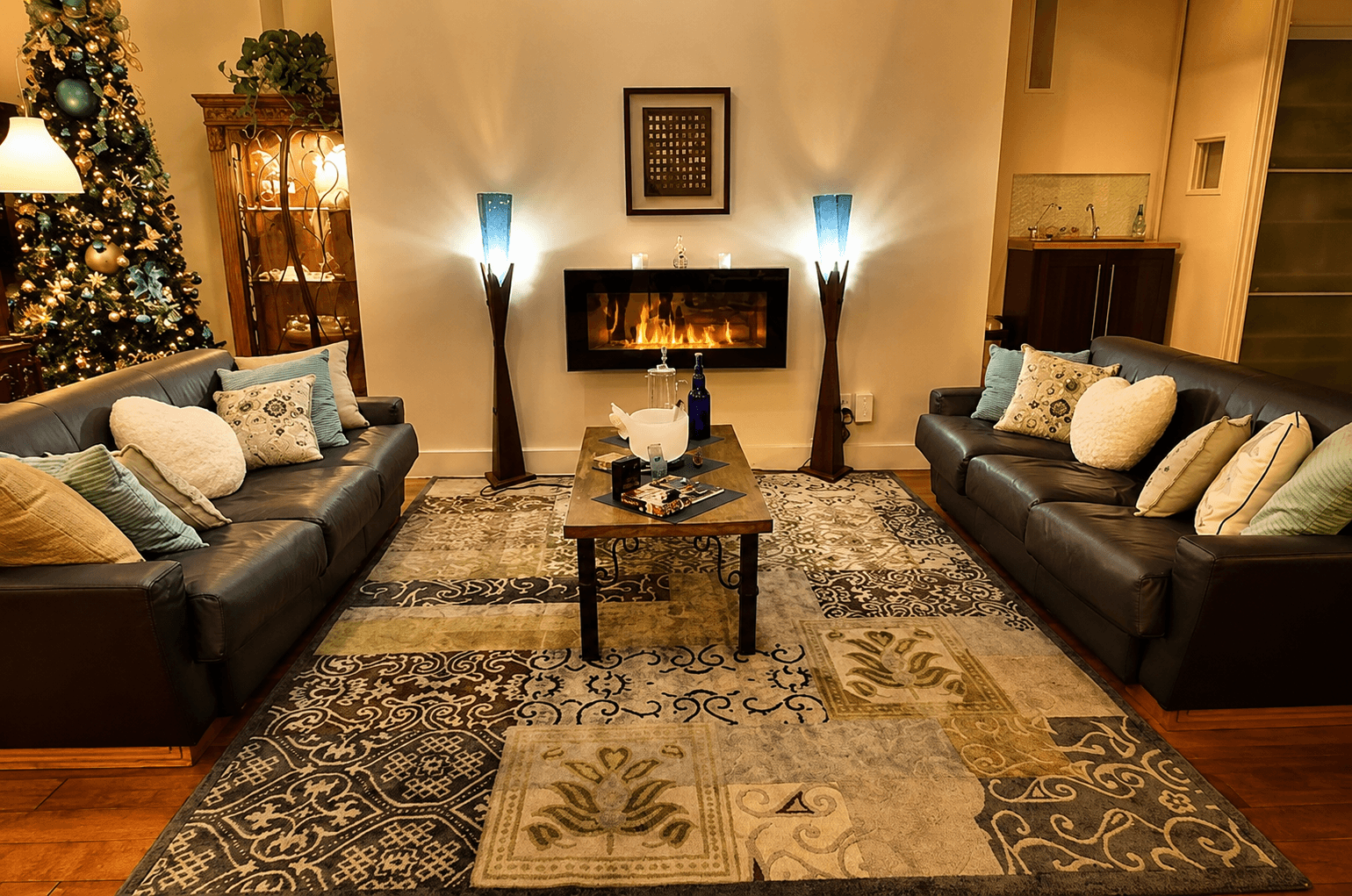 The Heart Center's living room, two facing leather sofas warmed by a fireplace and soft lamplight