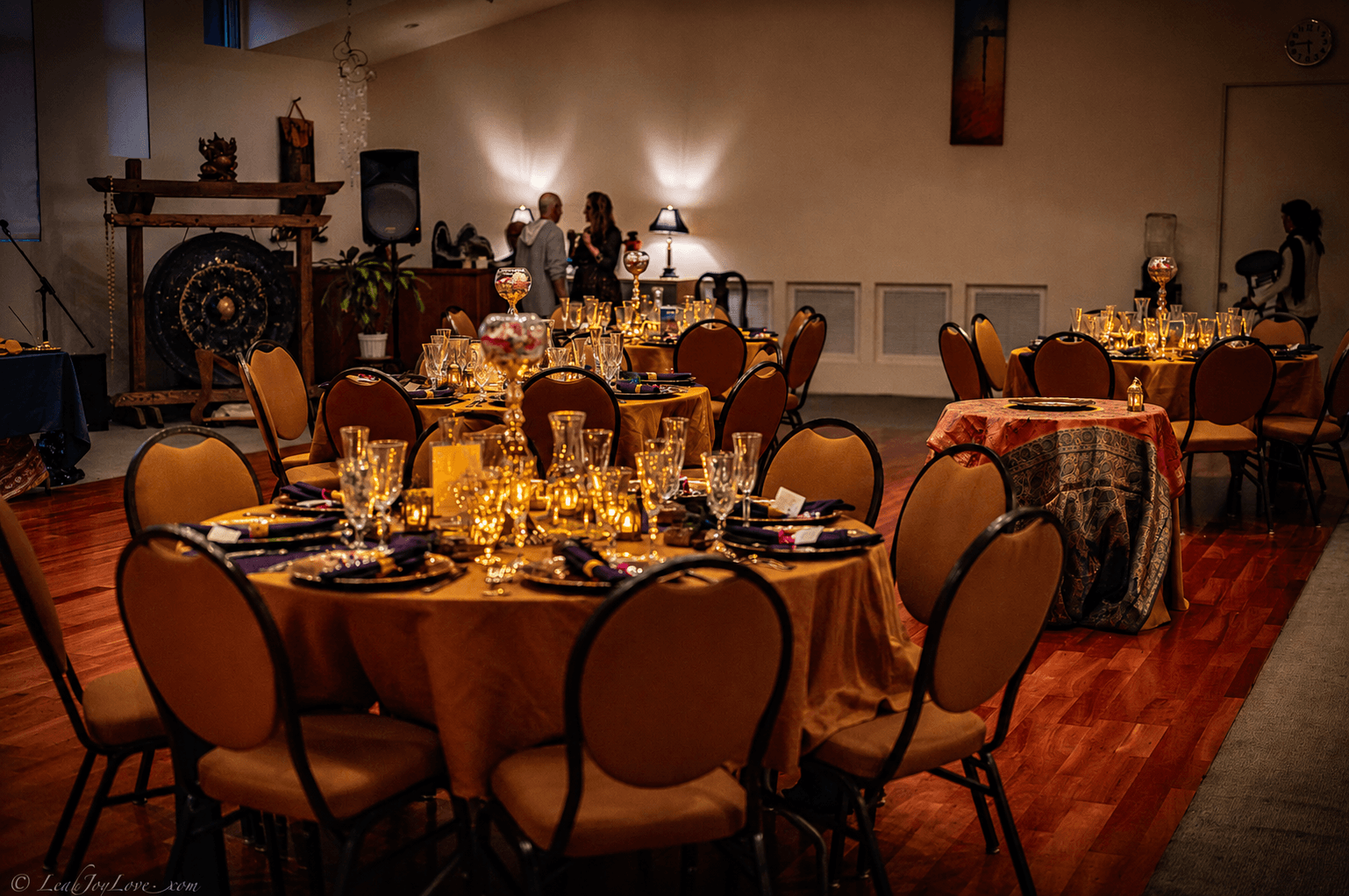 Candlelit tables set for shared meals and celebration dinners