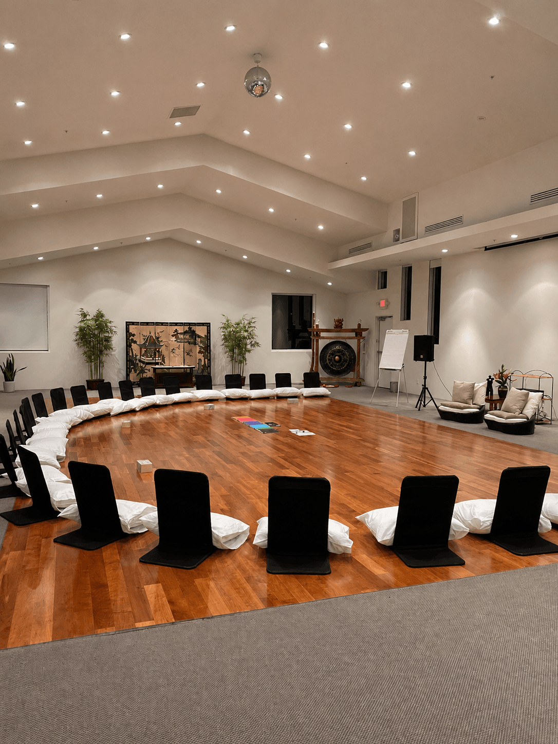 Chairs drawn into a wide circle around the gong