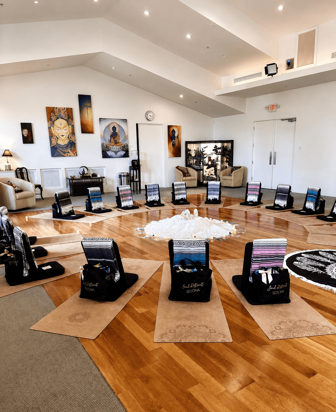 Mats and blankets ring a central altar of quartz clusters and candlelight, welcome bags waiting at every seat