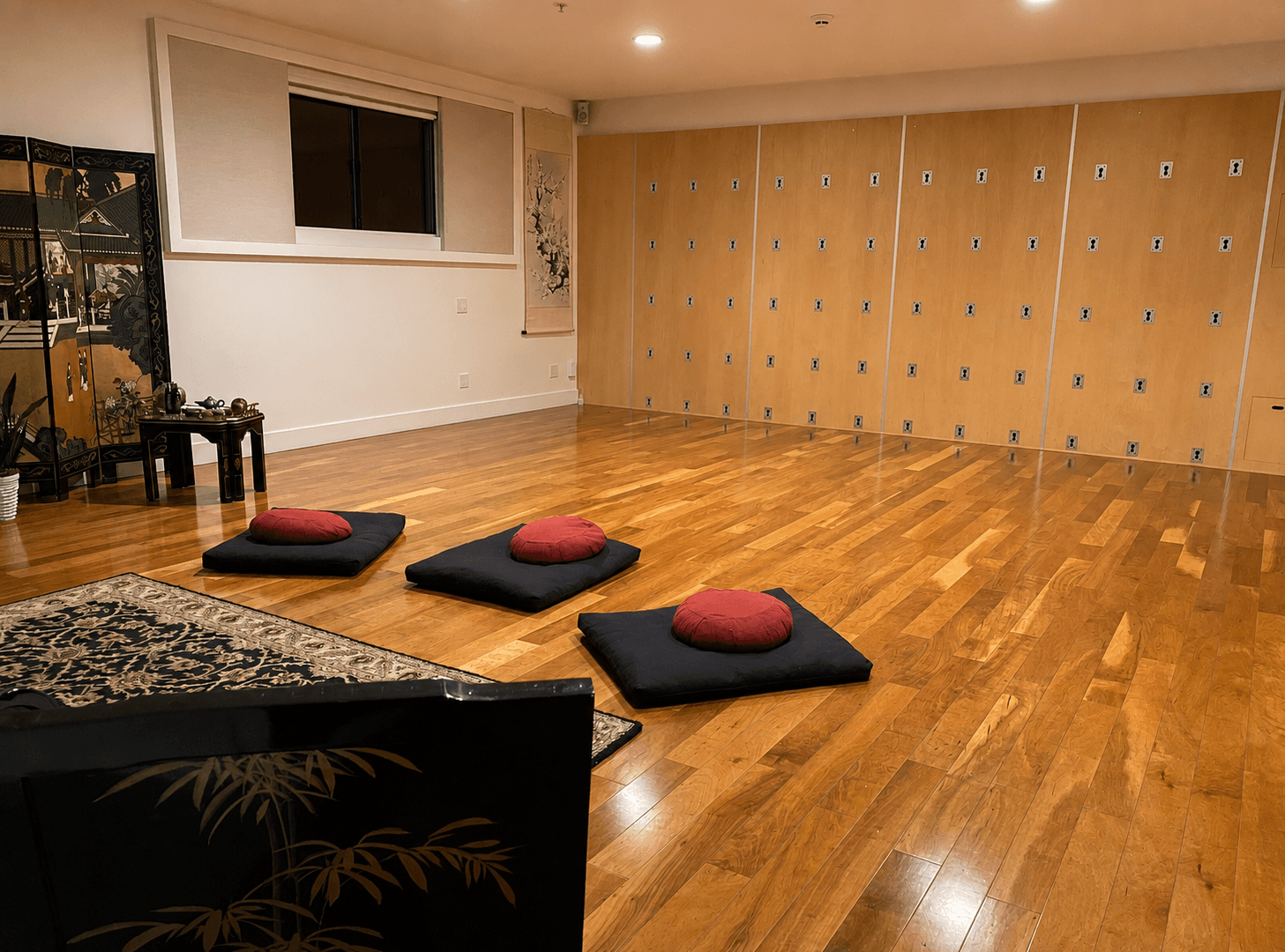 Meditation cushions arranged on the wood floor inside Guan Yin
