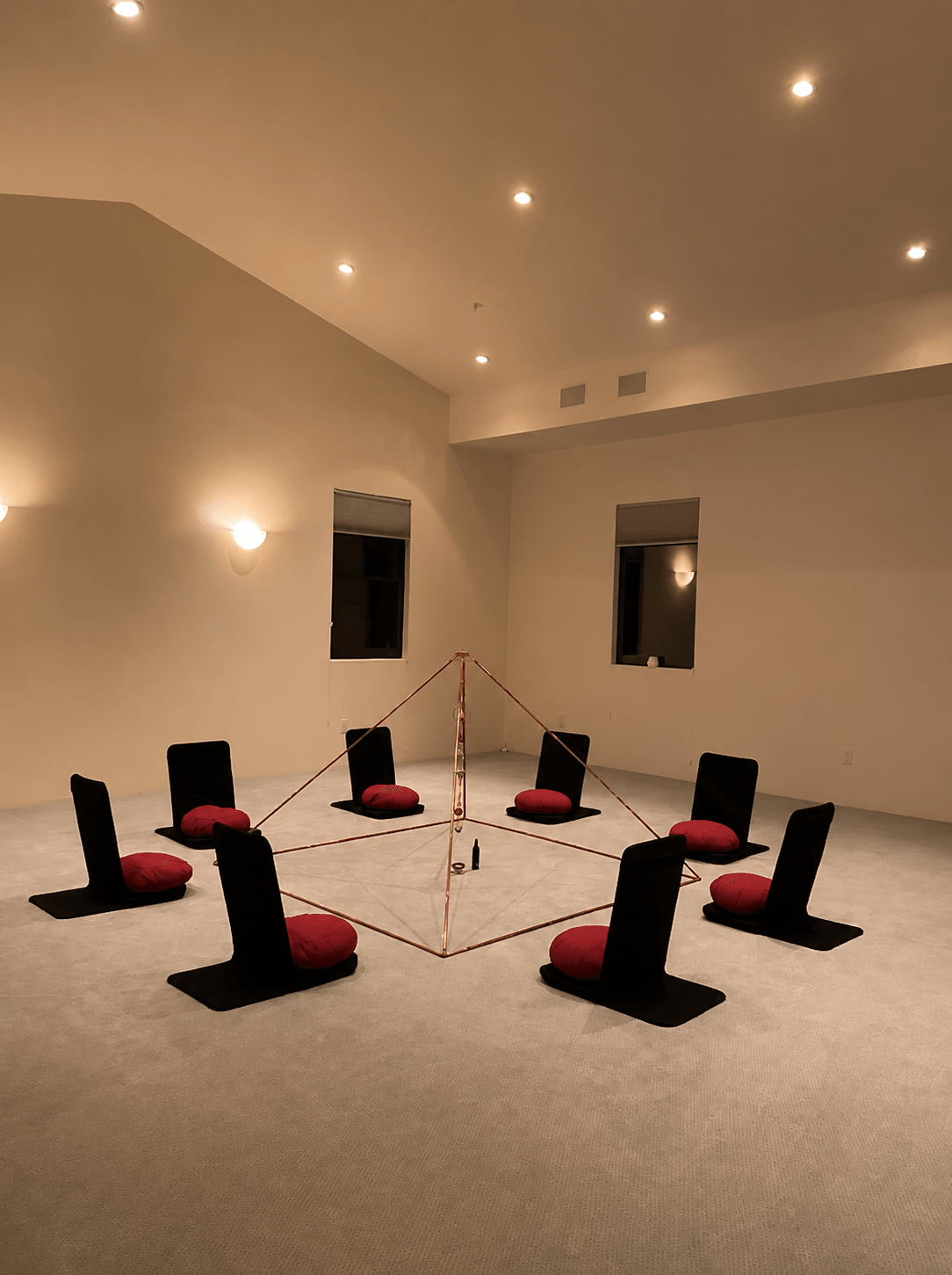 The room transformed by starlight projection for an evening sound bath