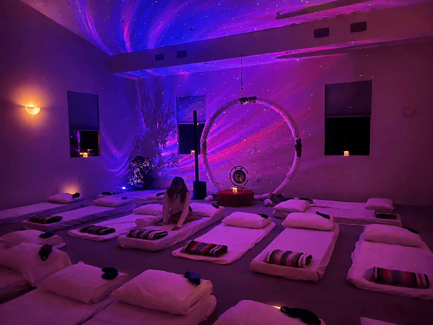 The gong and rows of cushions, gathered beneath a canopy of starlight